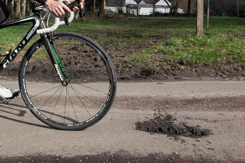 Cyclist with pothole