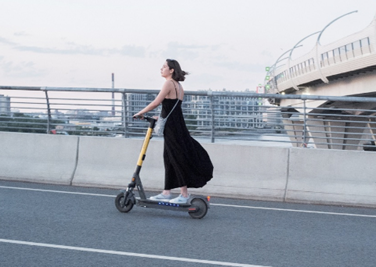 A girl riding an e-scooter