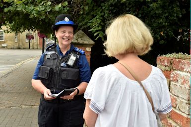 Image of Thames valley Police Local Neighbourhood Policing Team officer with a member of the oublic